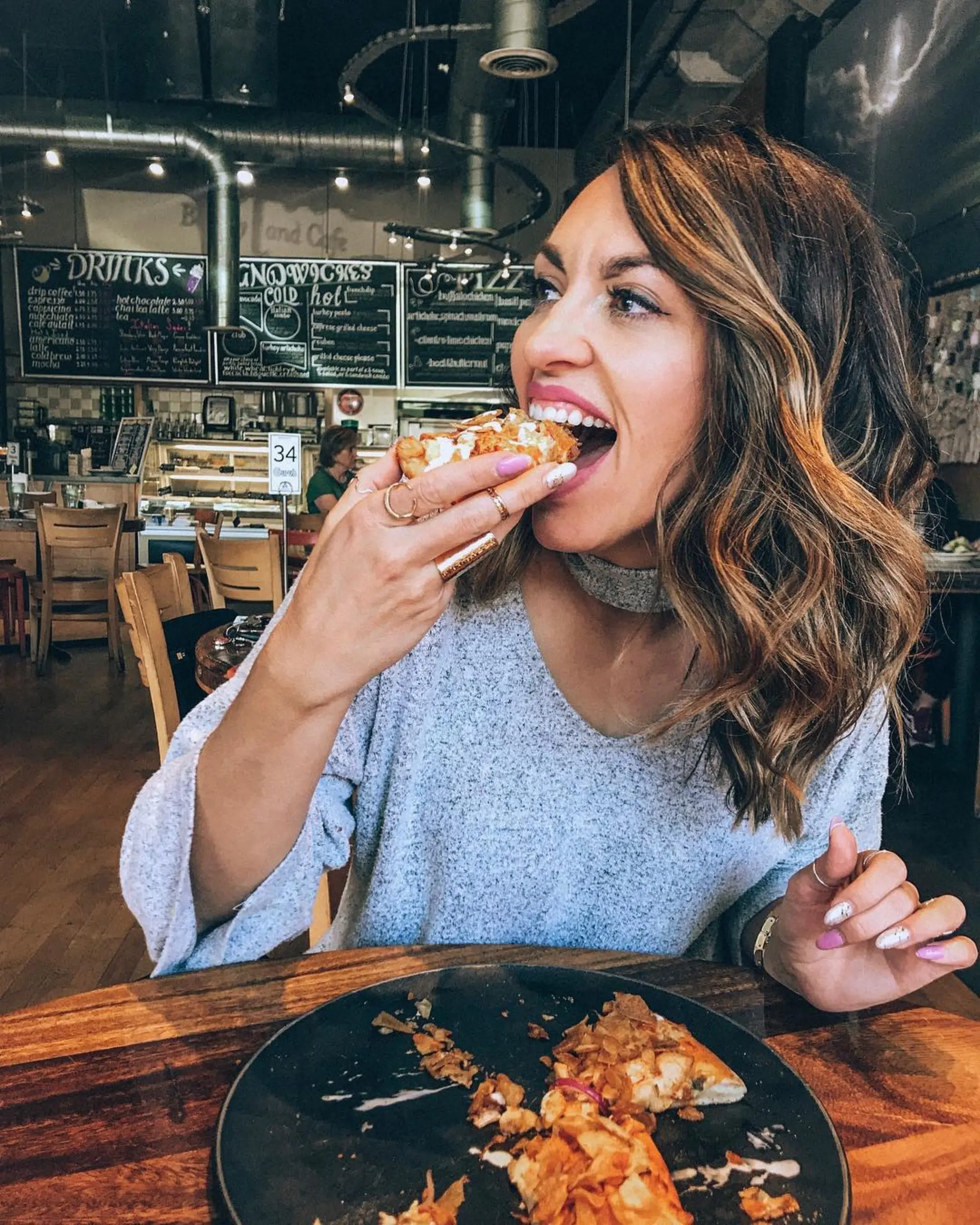 Female Model eating pizza in Enliten